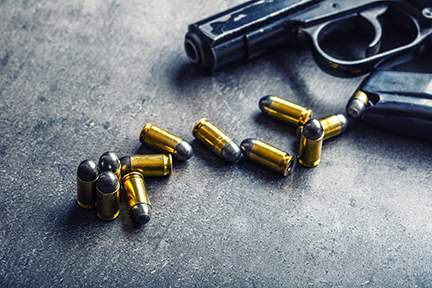 9 mm pistol gun and bullets strewn on the table