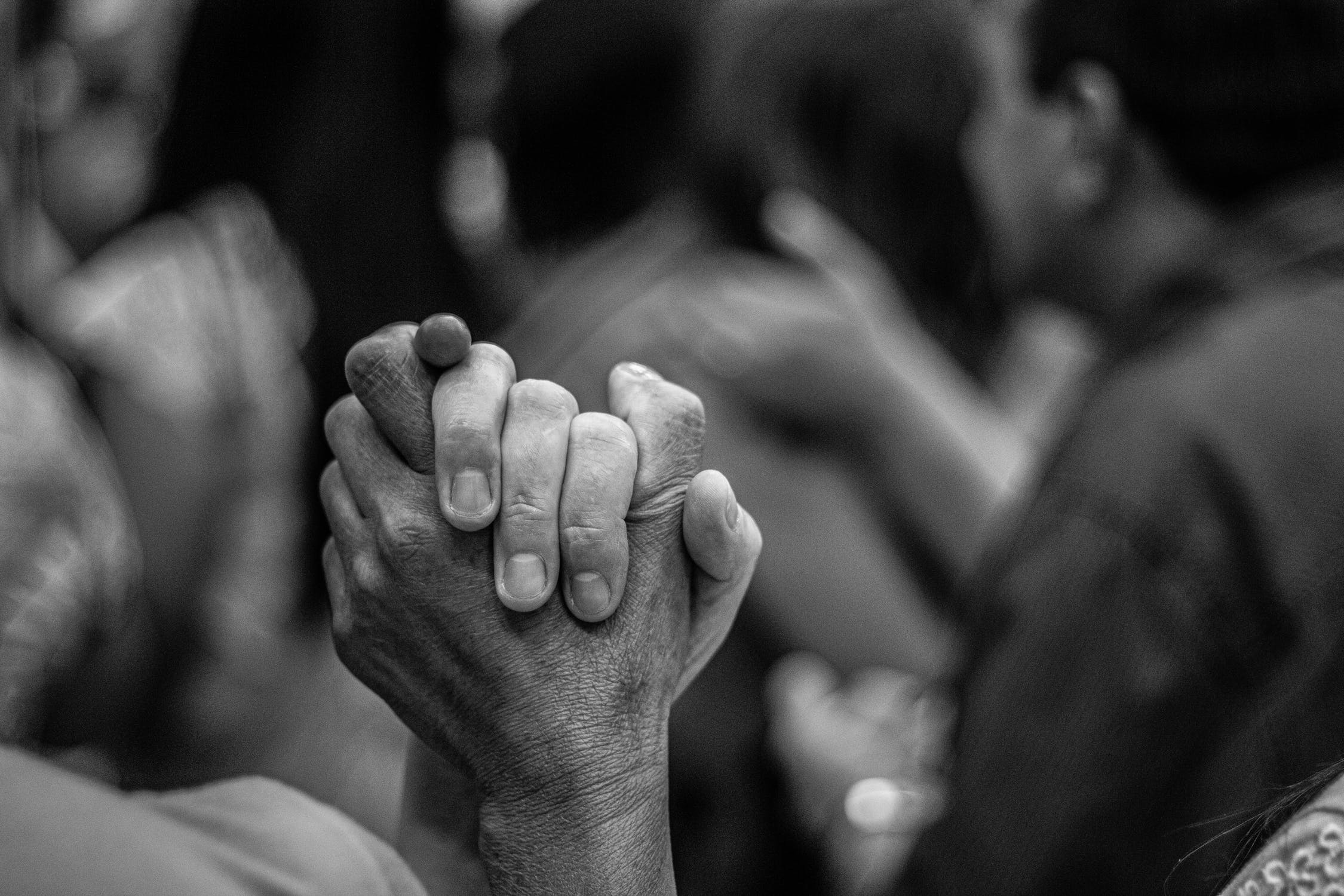 Two people clasping hands together