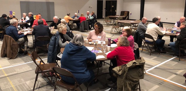 People gather around a table for conversation