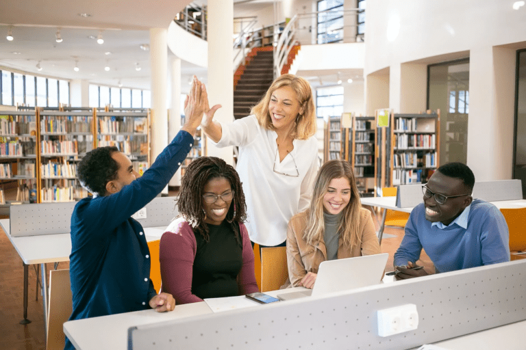 People high five in a library