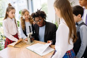 Students gather around a teacher